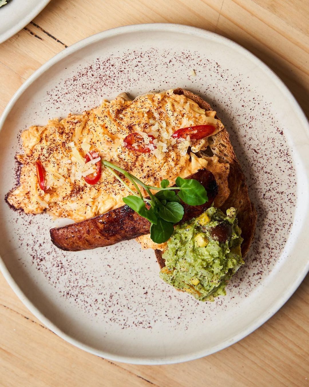 Chilli scrambled eggs on sourdough with chorizo, smashed avocado and a dusting of sumac
