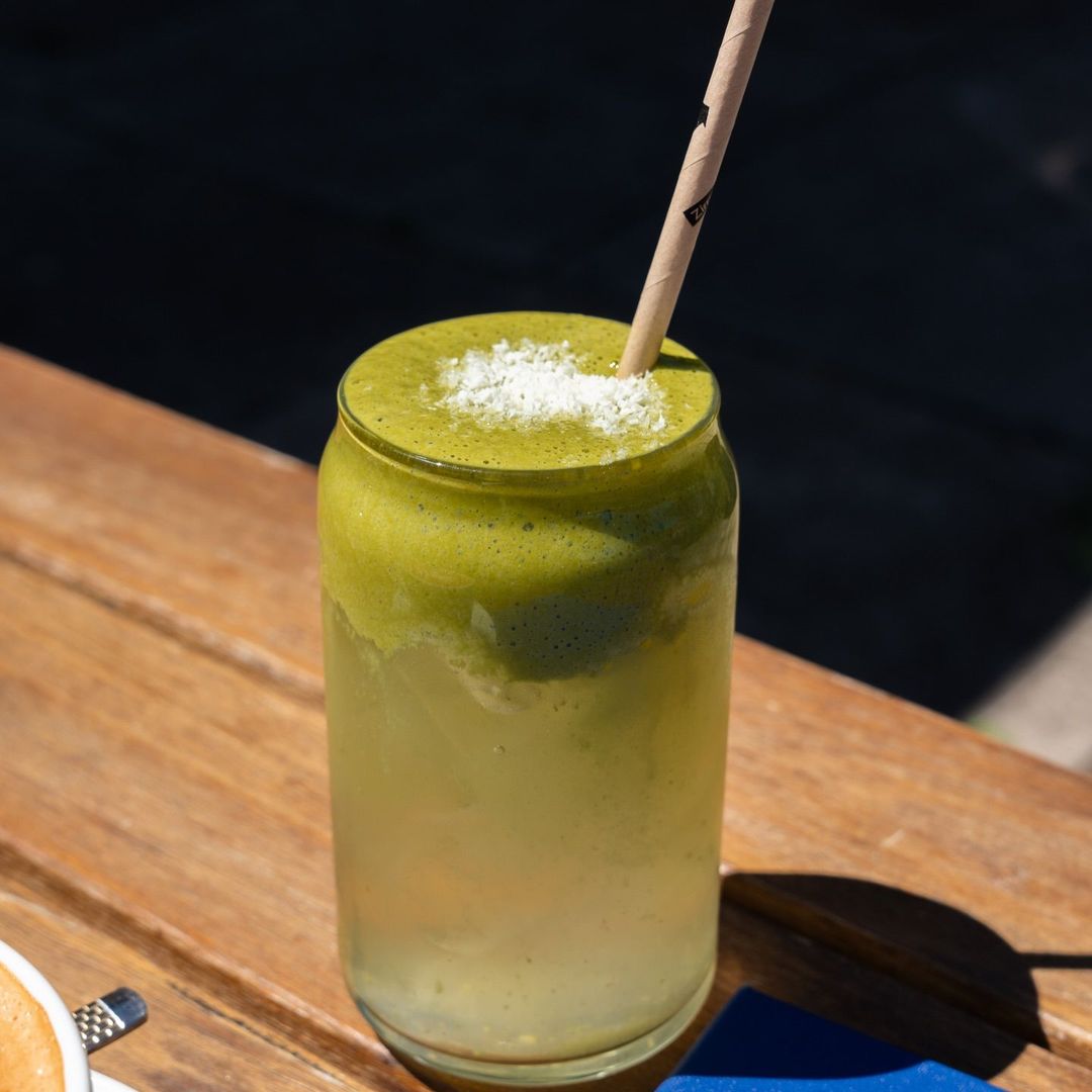 An iced coconut matcha dusted with shredded coconut at Drip Cafe